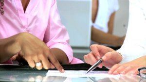 stock-footage-hands-only-of-multiethnic-businesswomen-signing-papers-in-a-modern-office